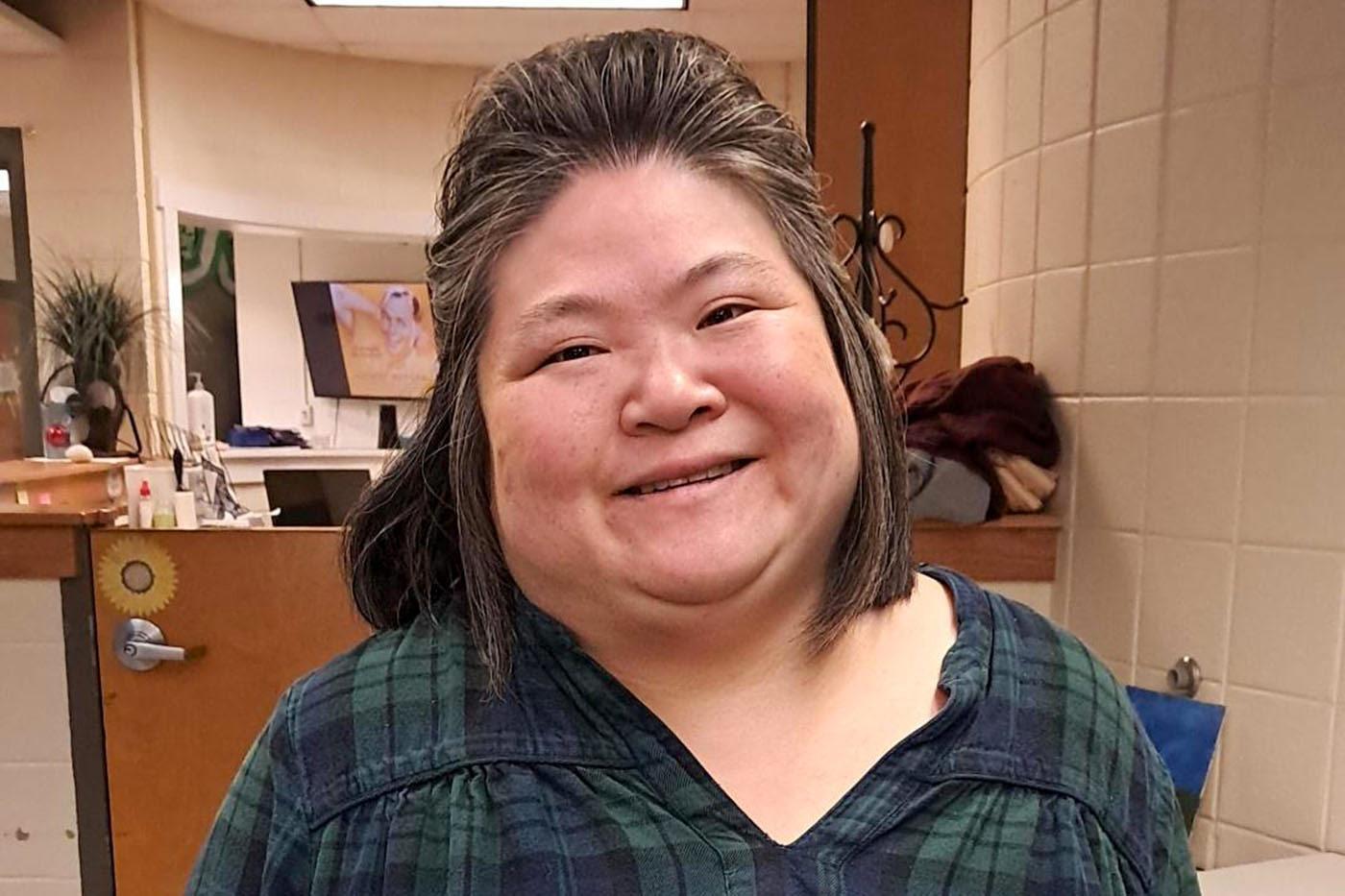 Hilltop Brain Injury Services resident smiling indoors on the Life Adjustment Program campus.